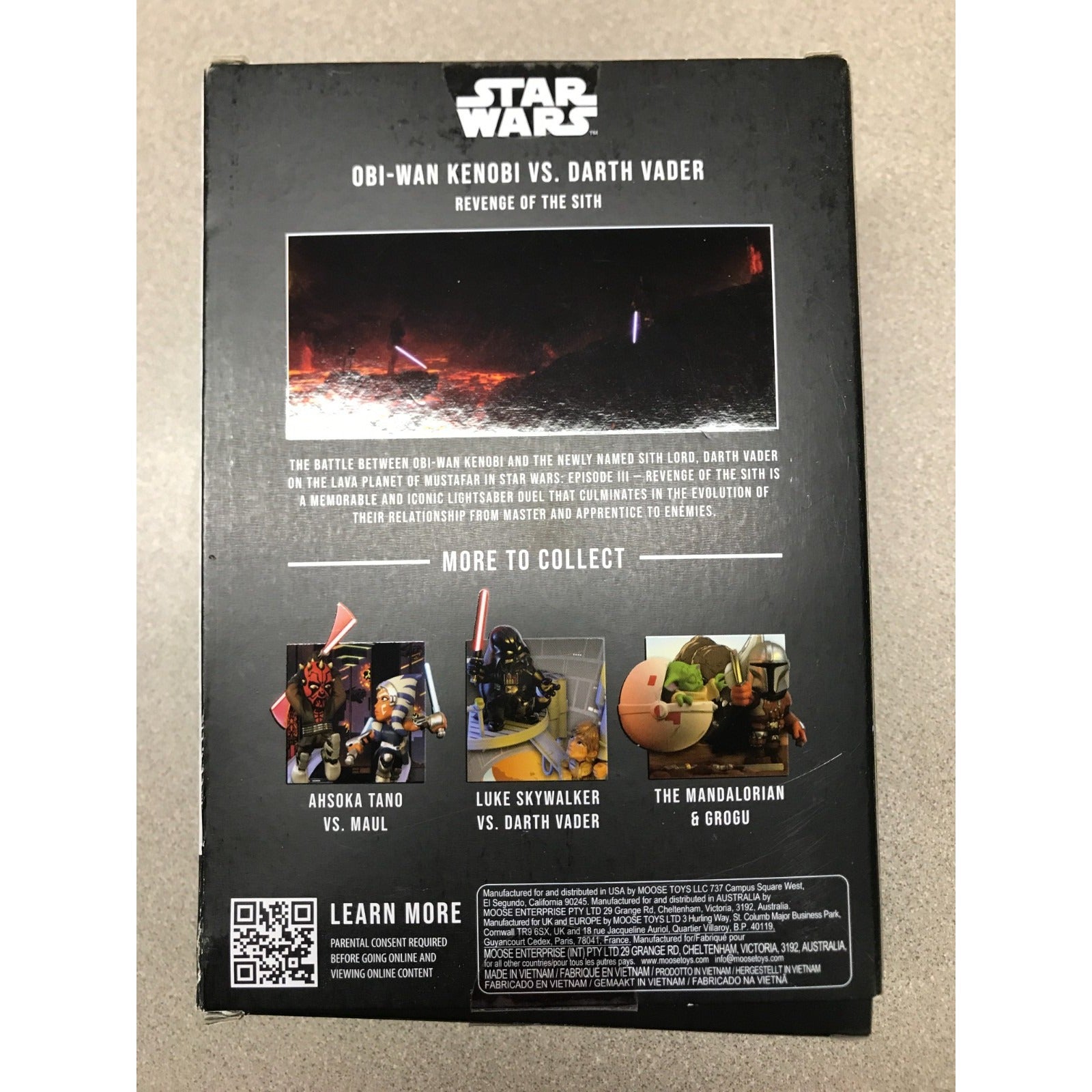 The back of a Star Wars Obi-Wan Kenobi vs. Darth Vader collectible box, showing product details, a movie still, and smaller collectible suggestions on a beige surface.