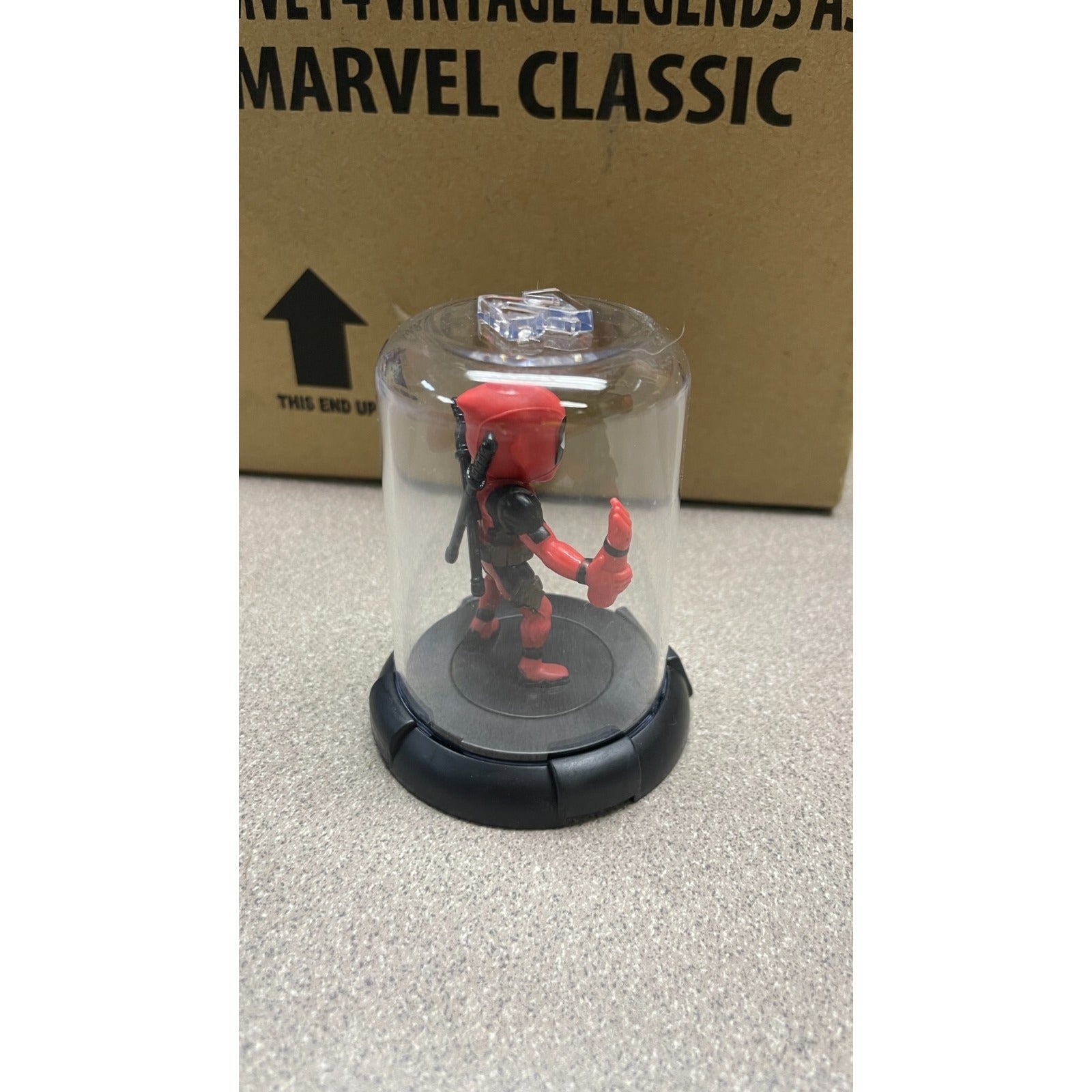 Domez Deadpool Collectible 2 of 8 (Missing Arm Pose) back/side view in display case