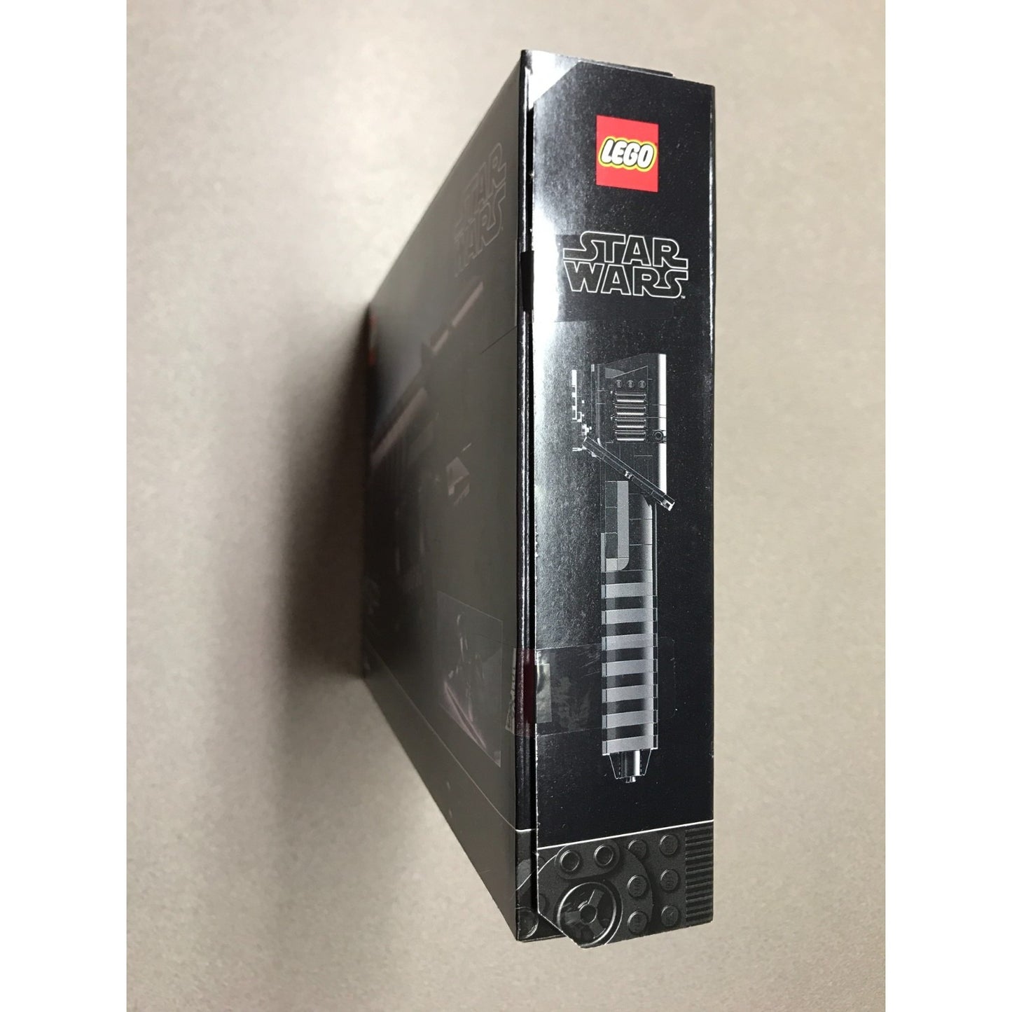 A LEGO Star Wars set box shown standing upright at a slight angle, displaying the LEGO logo and Star Wars branding on the black packaging against a plain beige background.