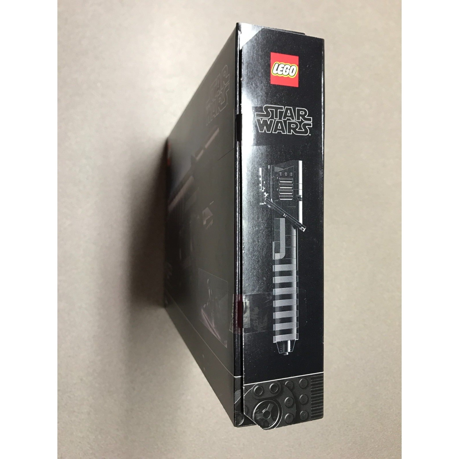 A LEGO Star Wars set box shown standing upright at a slight angle, displaying the LEGO logo and Star Wars branding on the black packaging against a plain beige background.