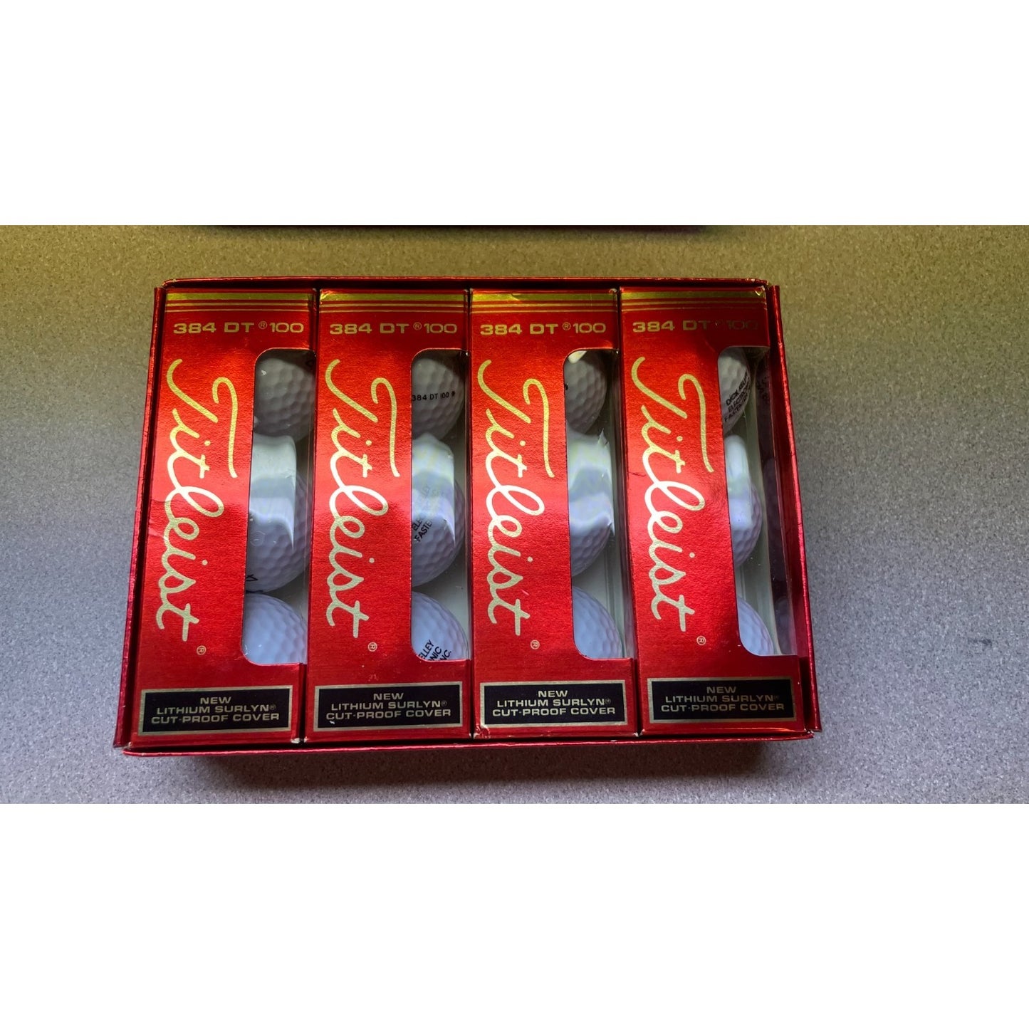 Titleist 384 DT 100 Compression Golf Balls 4 packs of 3 gold balls in box