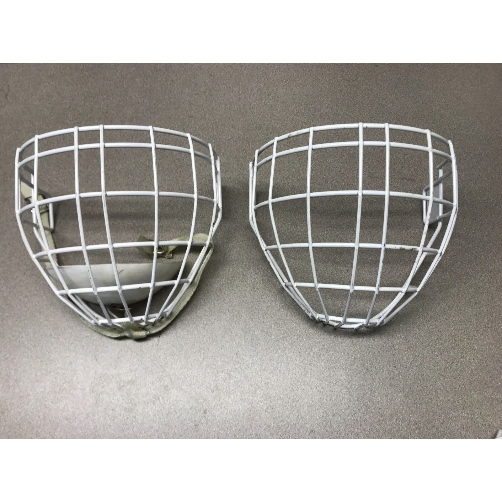 Two Hockey Cage Masks White Metal 7.5 inch (one with chin pad) front view