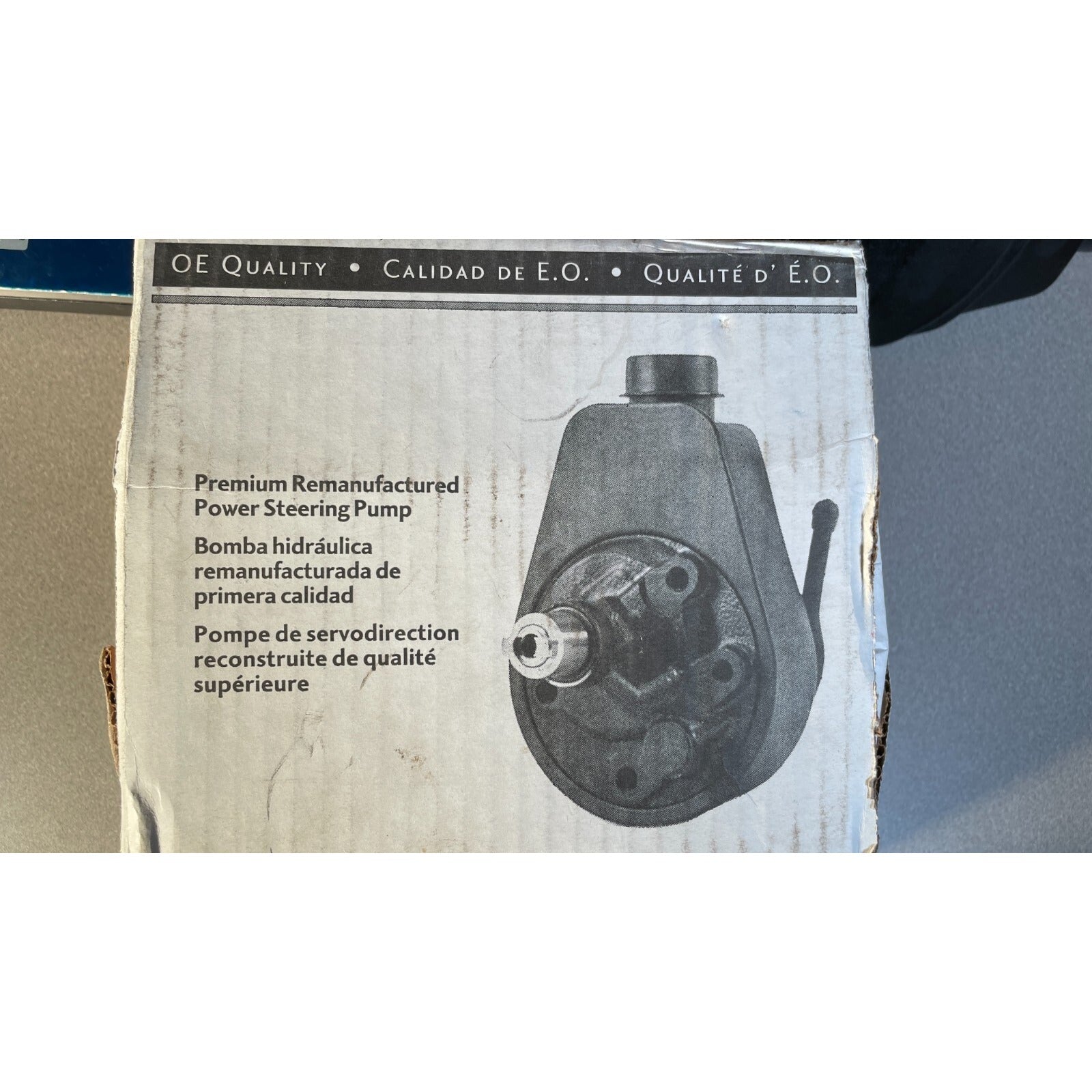 Box of a premium remanufactured power steering pump with text on it.