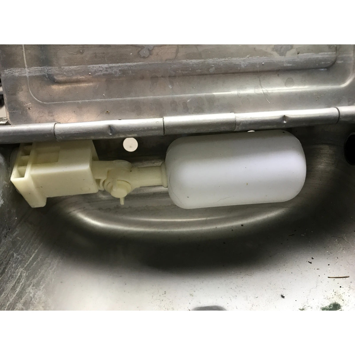 A replacement faucet fill valve assembly with a translucent white cylindrical body and a beige plastic connector, shown installed inside a stainless steel sink. Little Giant Automatic Waterer Livestock Water Bowls with Float Control - Set of 2