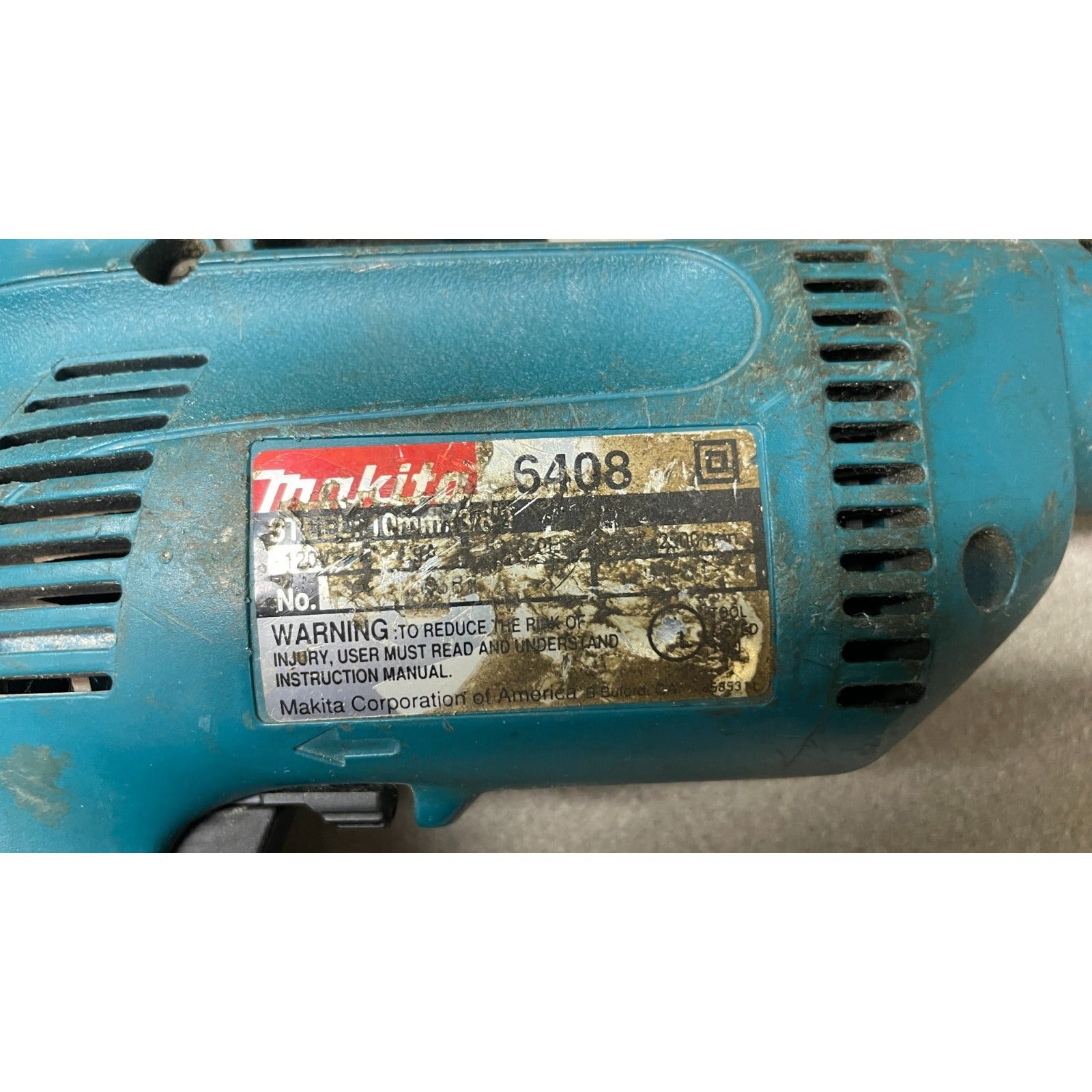 Makita 6408 Corded Drill closeup of product label worn