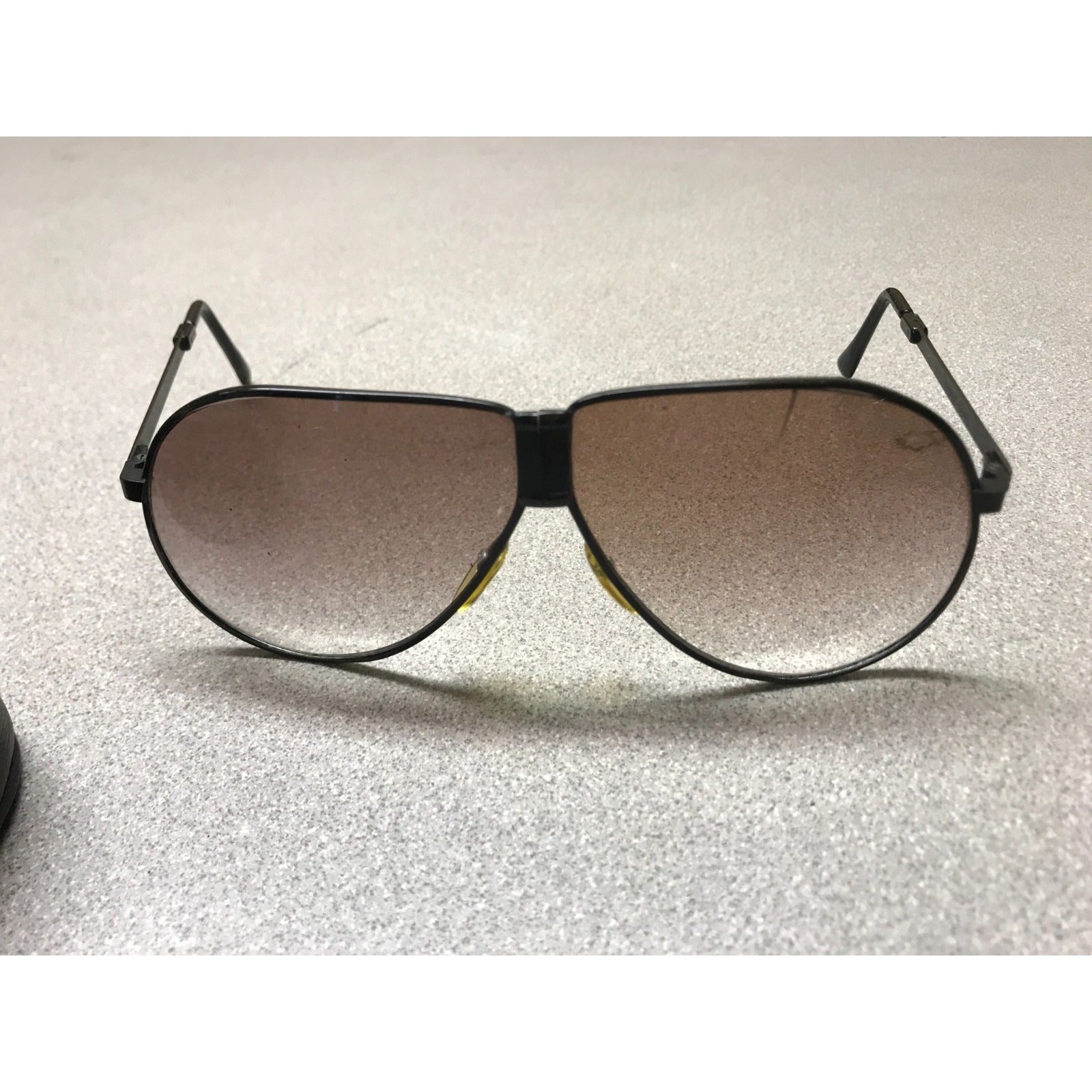 Vintage Foldable Ferrari Sunglasses with Leather Zipper Case, Metal frame with black case. front view of sunglasses