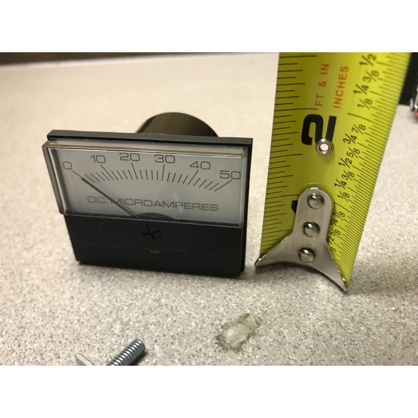 Modutec Panel Meter DC 0-50 Microamp Gauge Analog front view with measuring tape indicating approx. 2 in high