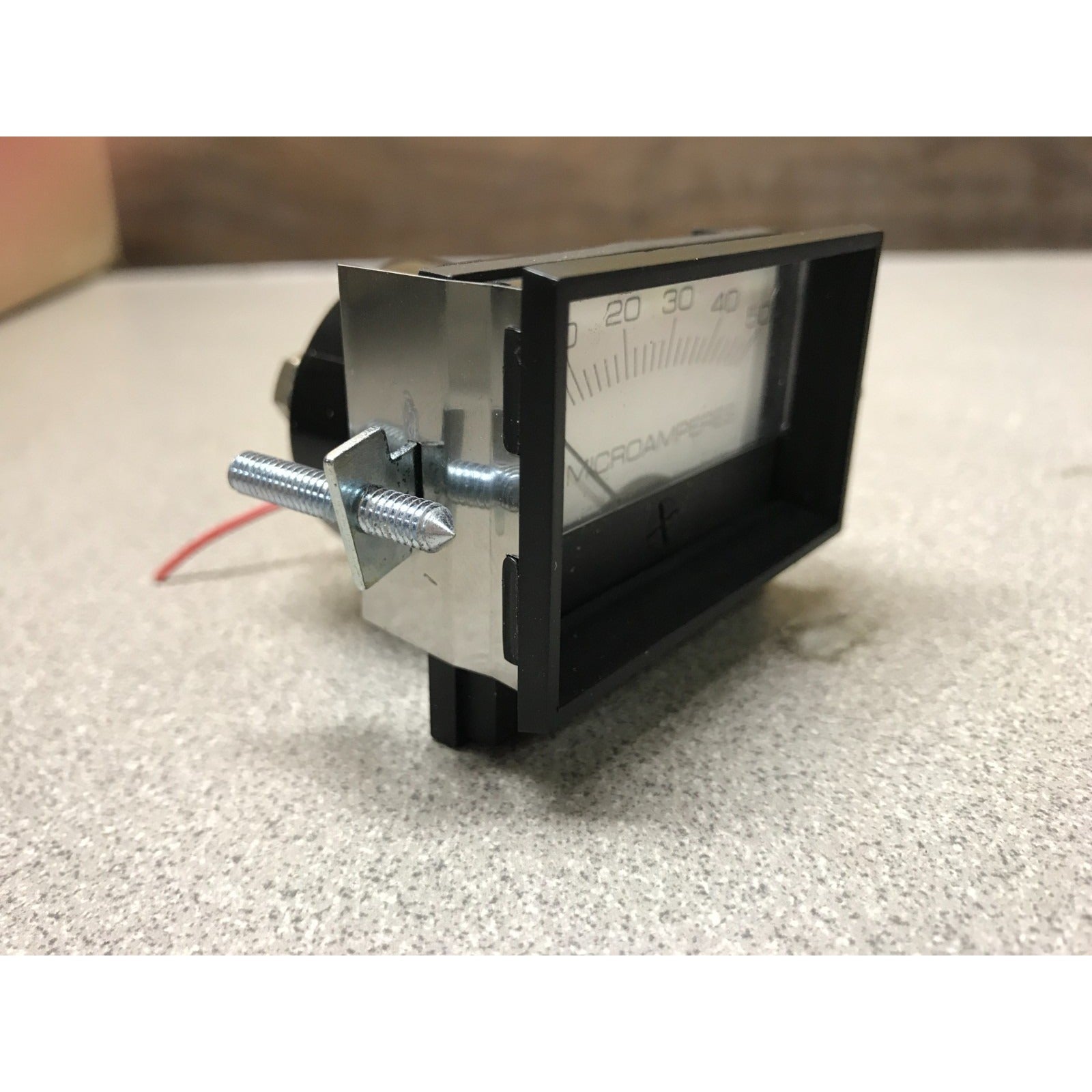 Modutec Panel Meter DC 0-50 Microamp Gauge Analog side view of gauge in frame with screw