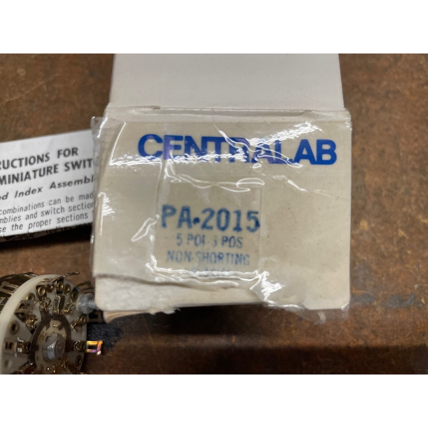 Packaged component with 'Centralab' branding on a wooden surface