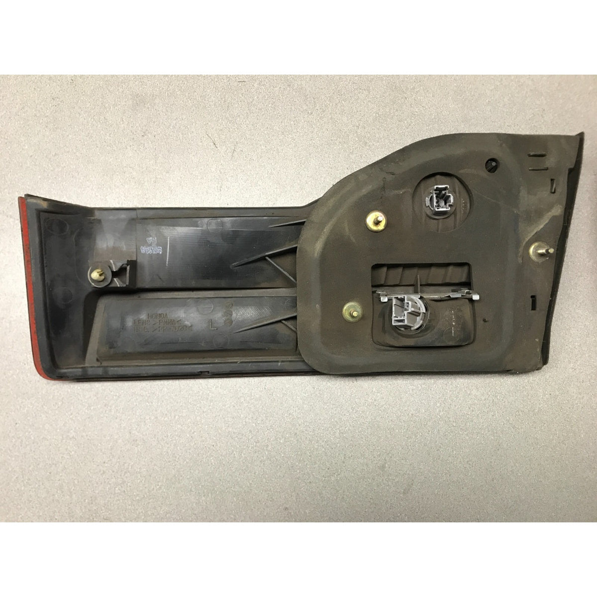 A used black plastic automotive tailgate light assembly with mounting hardware, photographed on a neutral light gray background. 2001-2002 Honda Accord Sedan OEM Tail Lights - Full Set back view