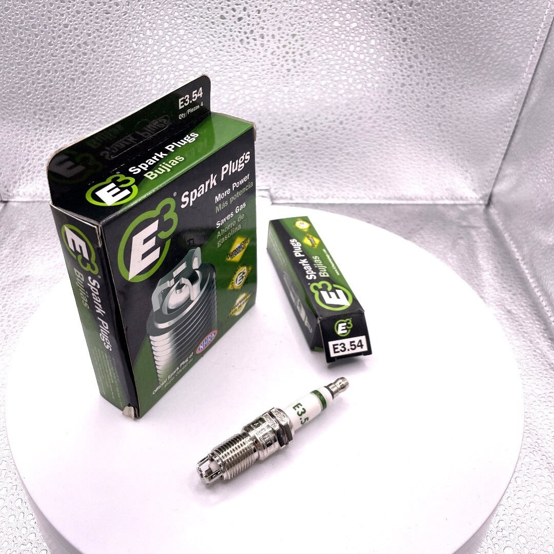 Spark plugs and packaging on a white background