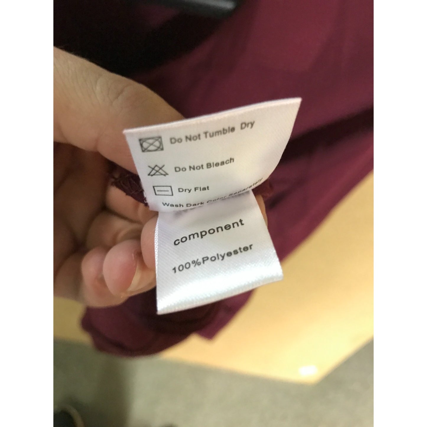 Washing instructions label on a garment with a blurred background