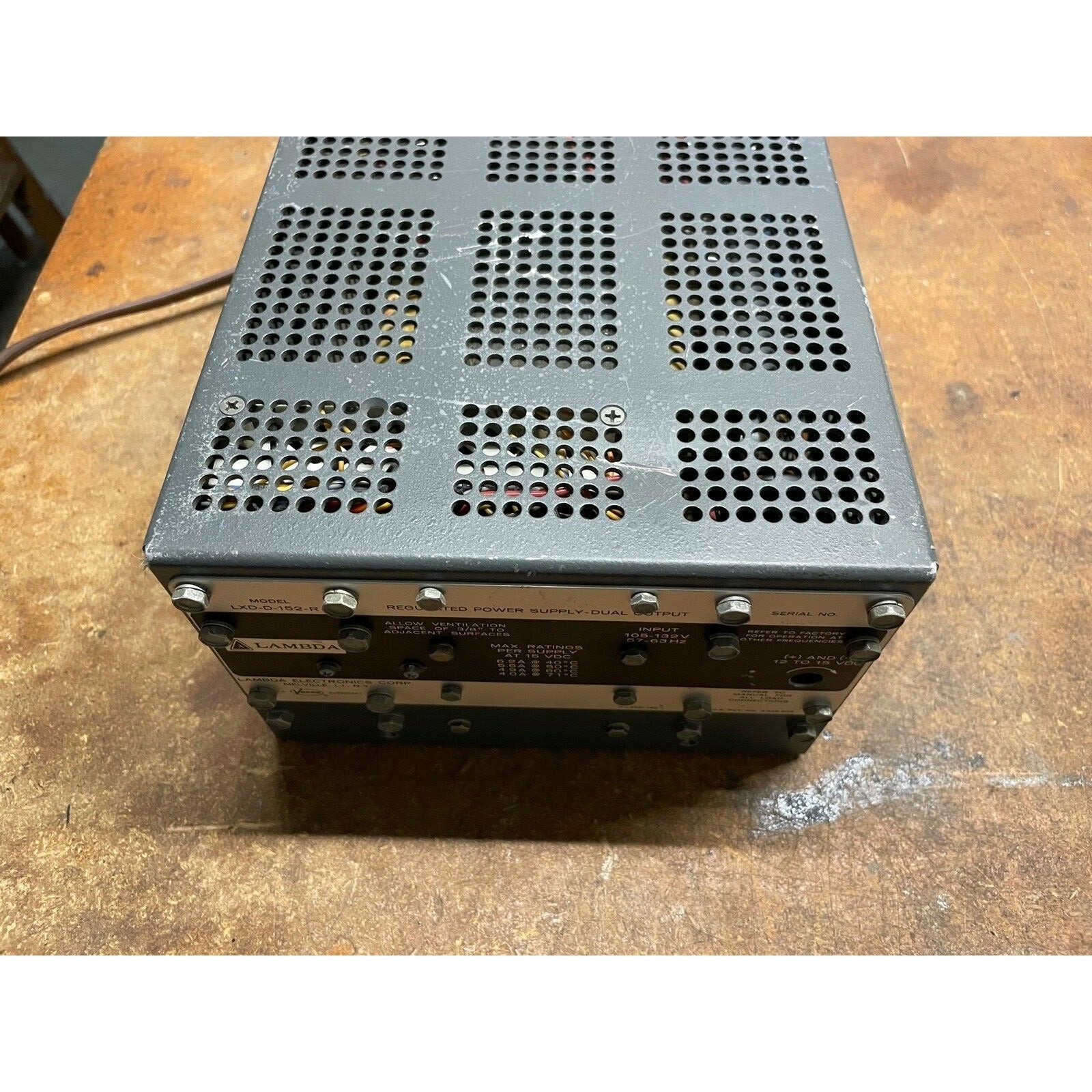 Lambda LXD-D-152-R regulated power supply top view showing small dent