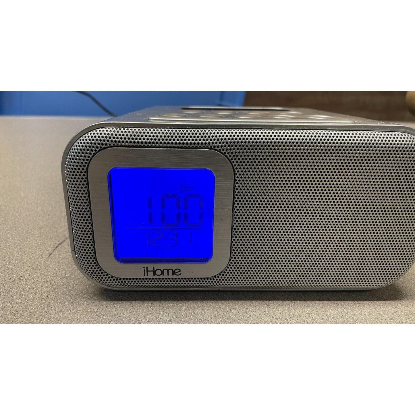 iHome clock radio with digital display on a beige surface