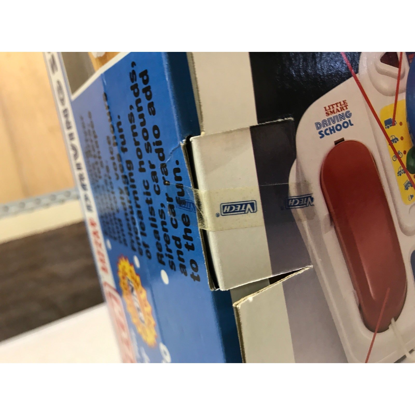 Vintage VTECH Little Smart Driving School closeup of sealed box opening