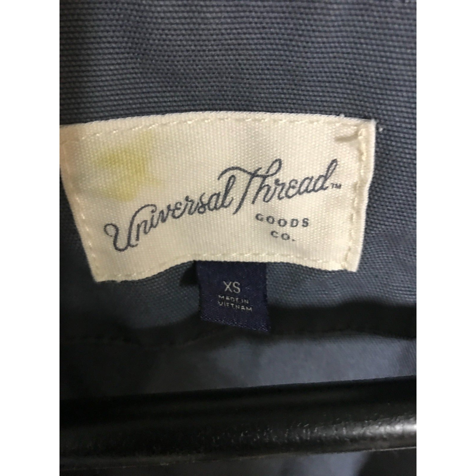 Label with 'Universal Thread Goods Co.' on a dark fabric background