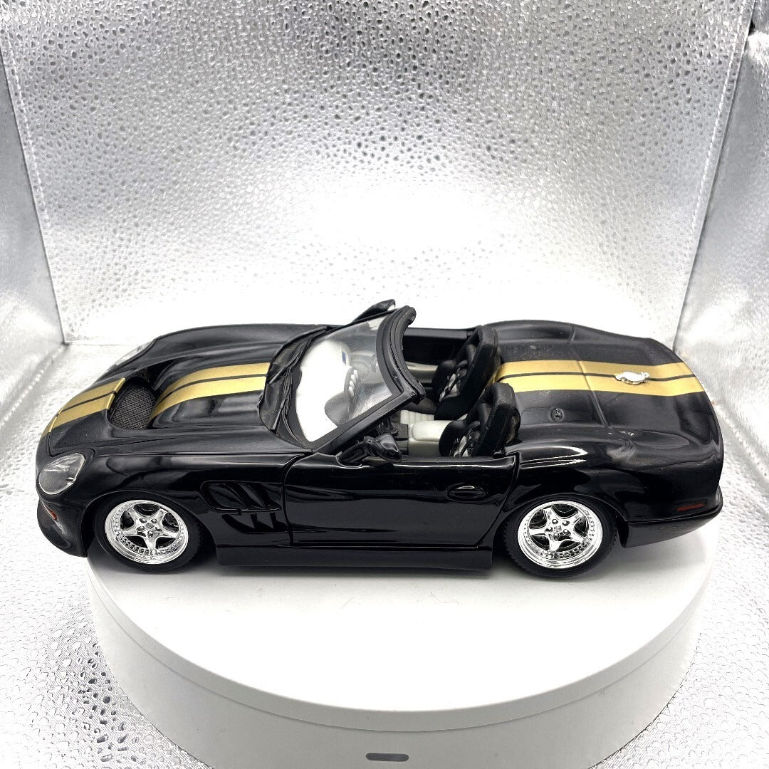 Maisto 1999 Shelby Series 1 Black and Gold Die Cast, 1/18 Scale driver's side view