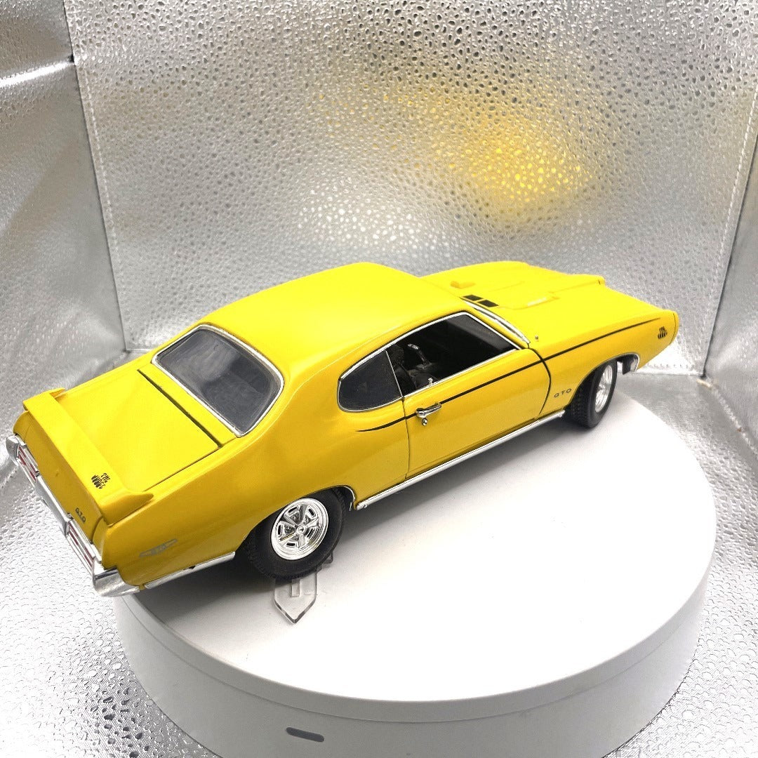 Motor Max 1969 Pontiac GTO "Judge" Yellow Die Cast, Scale: 1/18, 73133 back end/passenger side view