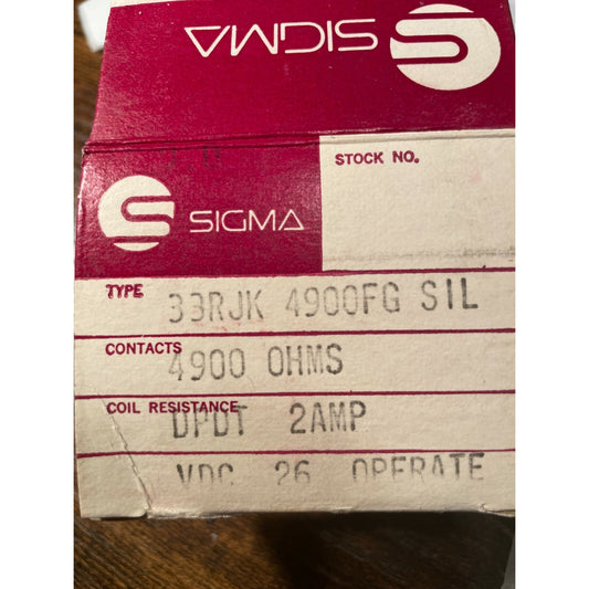 Sigma electrical component box with text on a wooden surface