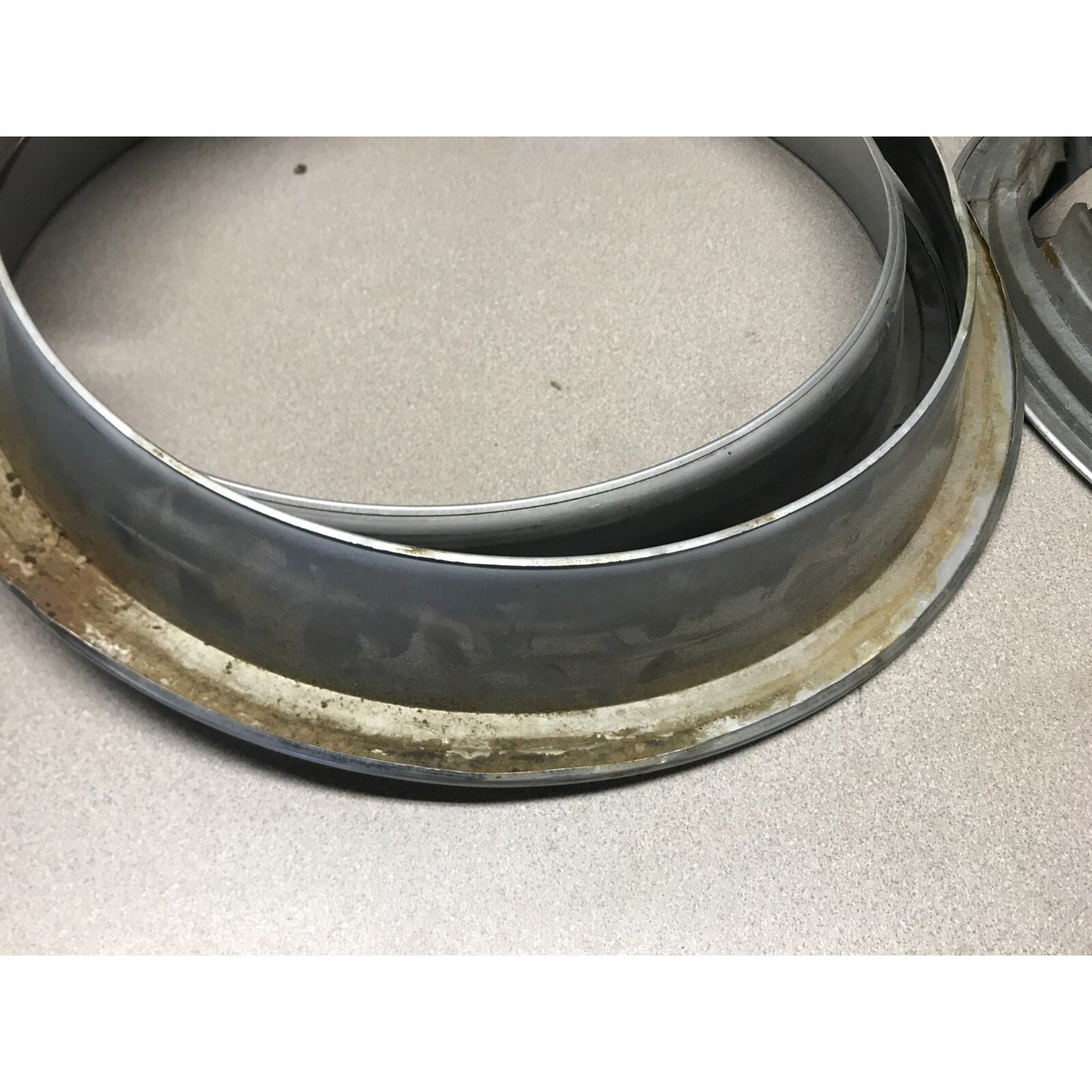 Lot 4 Unmatching 1966 Pontiac GTO OEM Wheel Trim Rings close up shows dirt