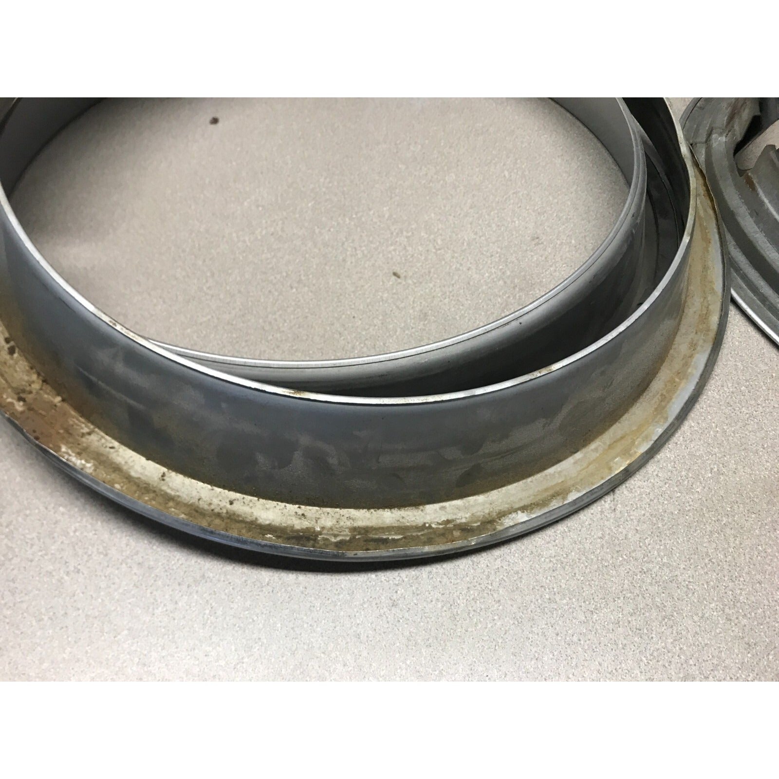 Lot 4 Unmatching 1966 Pontiac GTO OEM Wheel Trim Rings close up shows dirt