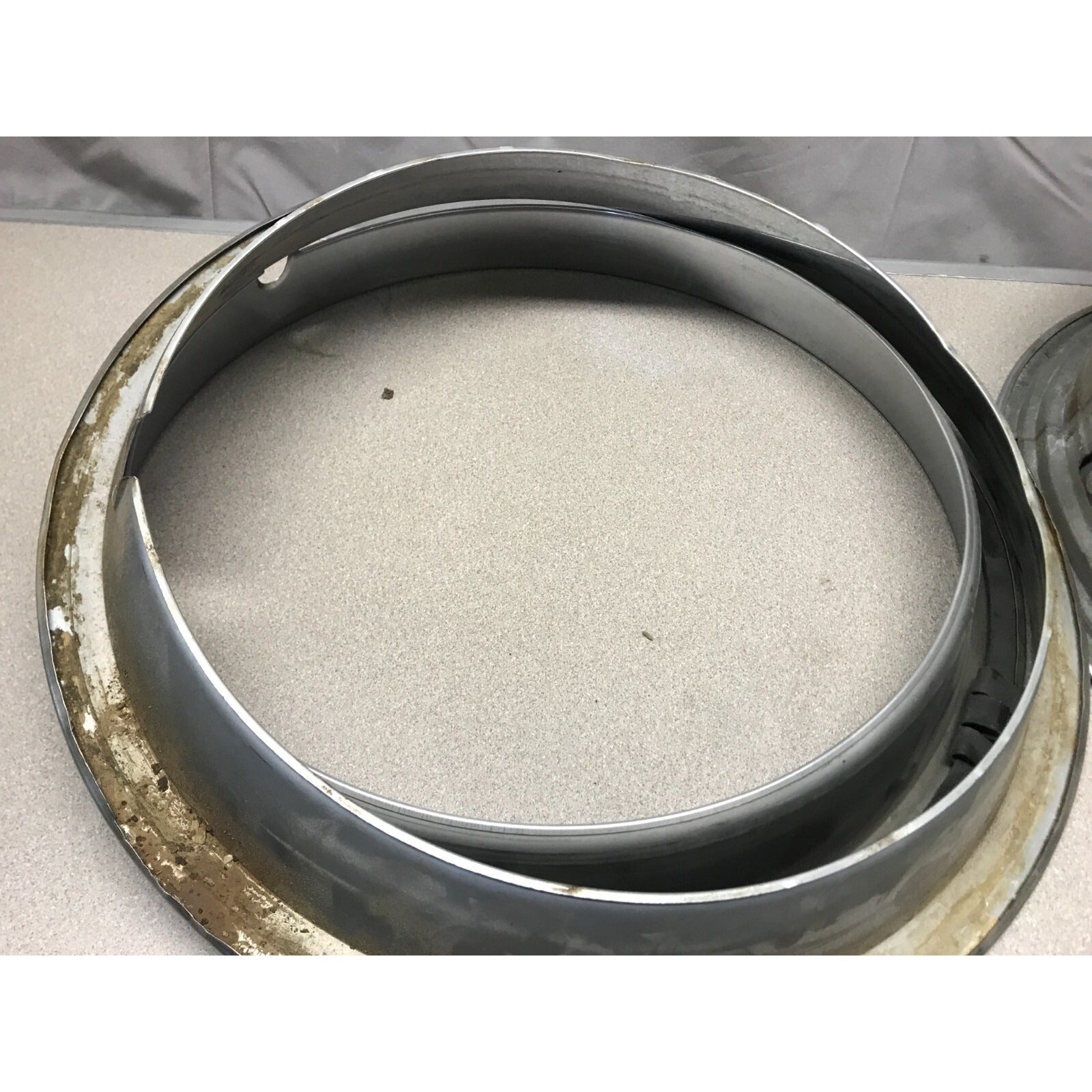 Lot 4 Unmatching 1966 Pontiac GTO OEM Wheel Trim Rings back side shows dirt rust