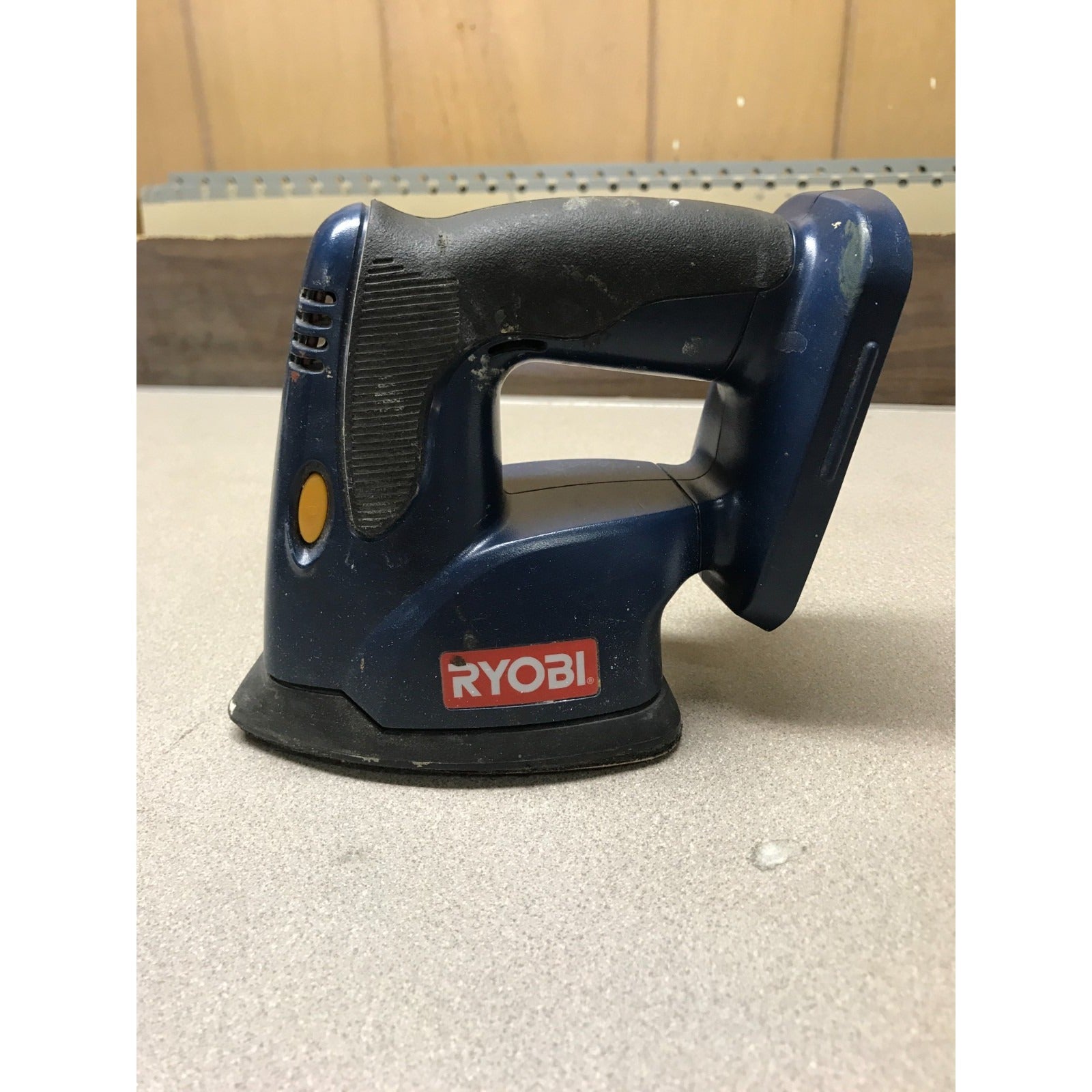 RYOBI P400 Handheld Sander, 18v. side view of sander resting on sanding pad