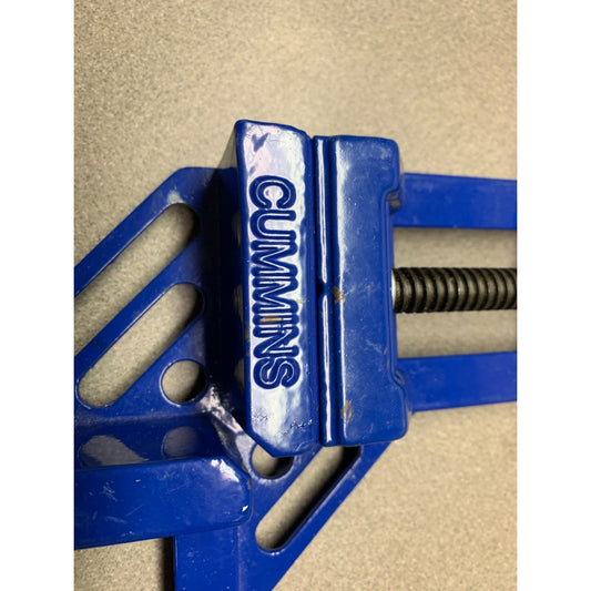 Blue vise with 'Cummins' branding on a beige background