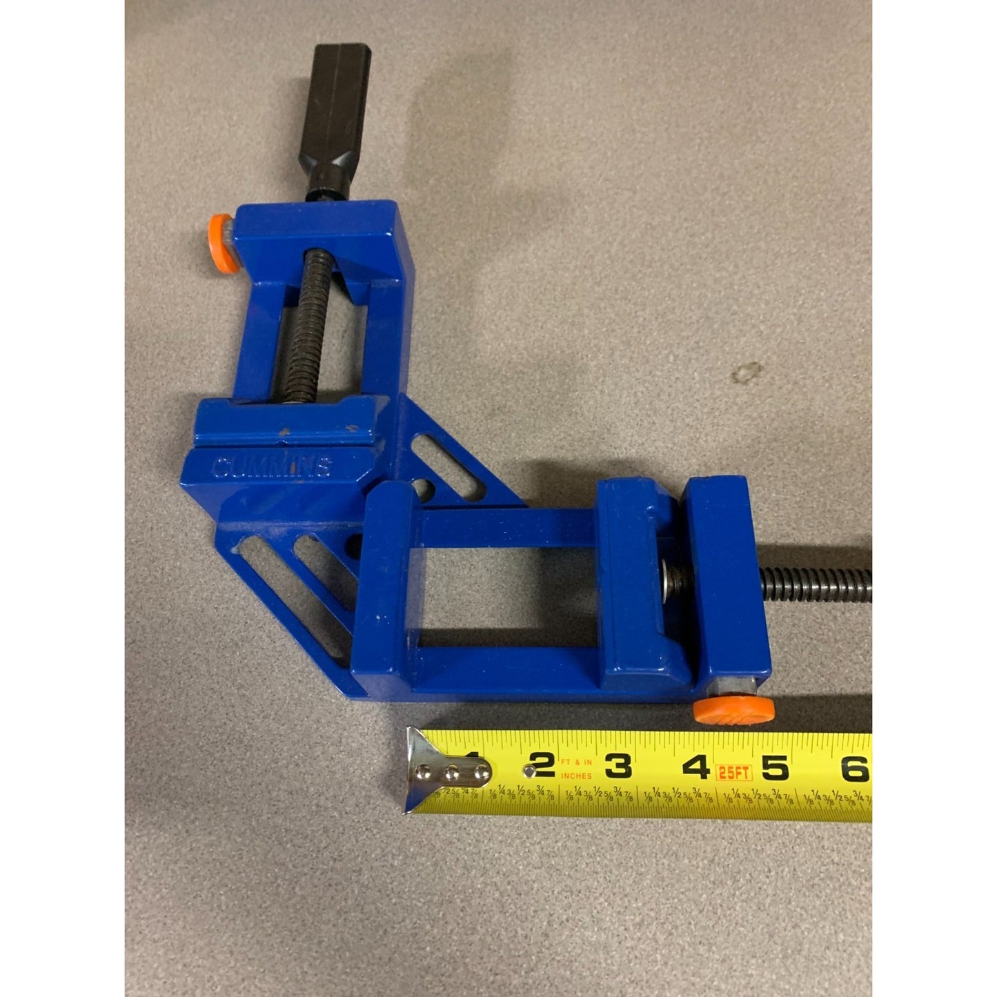 Cummins Tools 4" Corner Clamp with Quick Release with measuring tape indicating length of angle 4 inches
