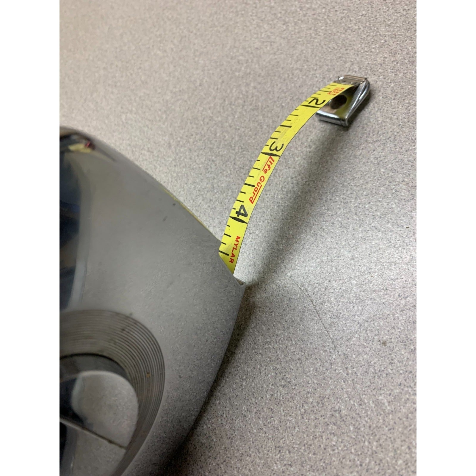 Vintage Measuring Tape 100ft Stanley Steelmaster closeup of extended tape 4 inches