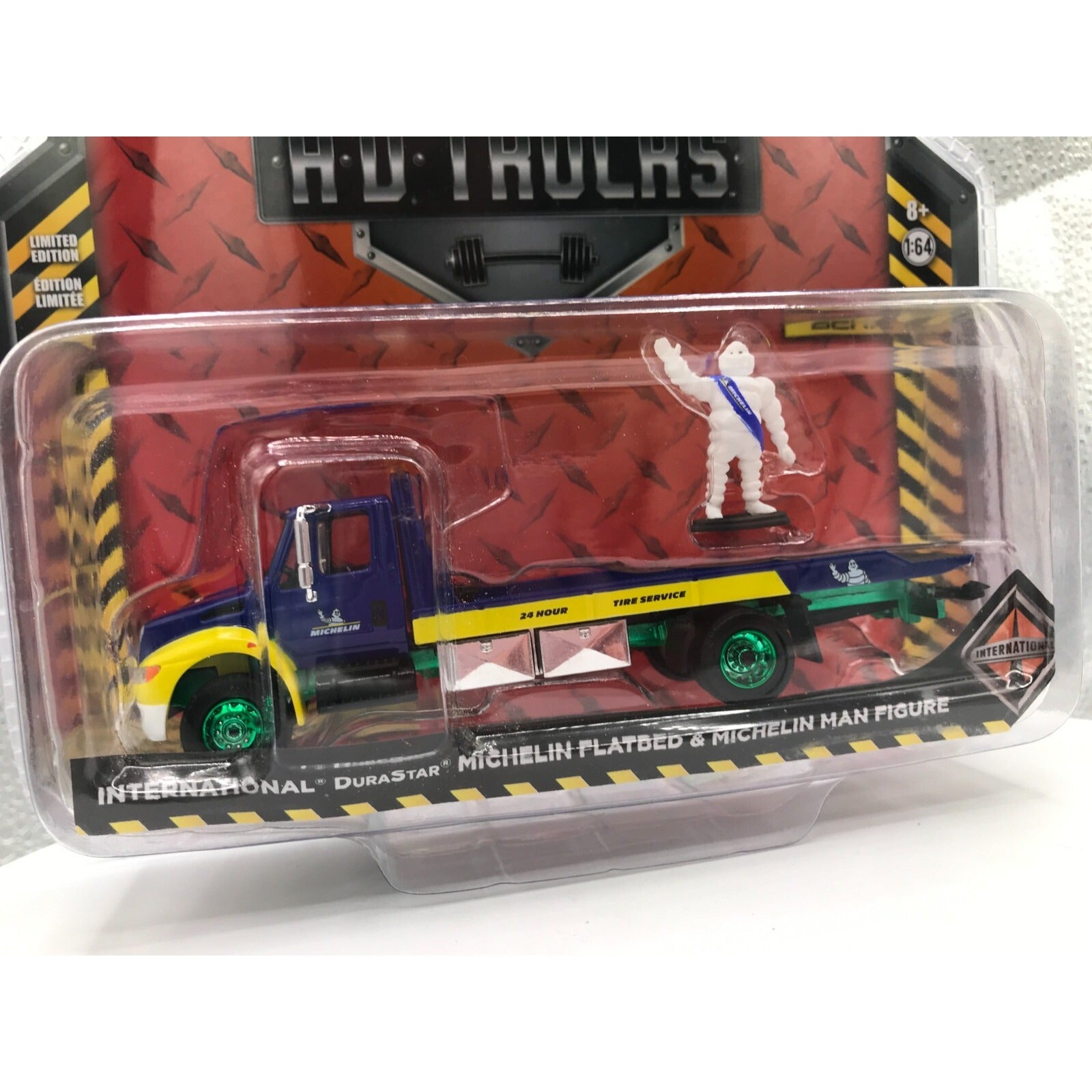 Greenlight HD Trucks Chase Michelin Flatbed &amp; Michelin Man Figure front of package closeup of truck and action figure