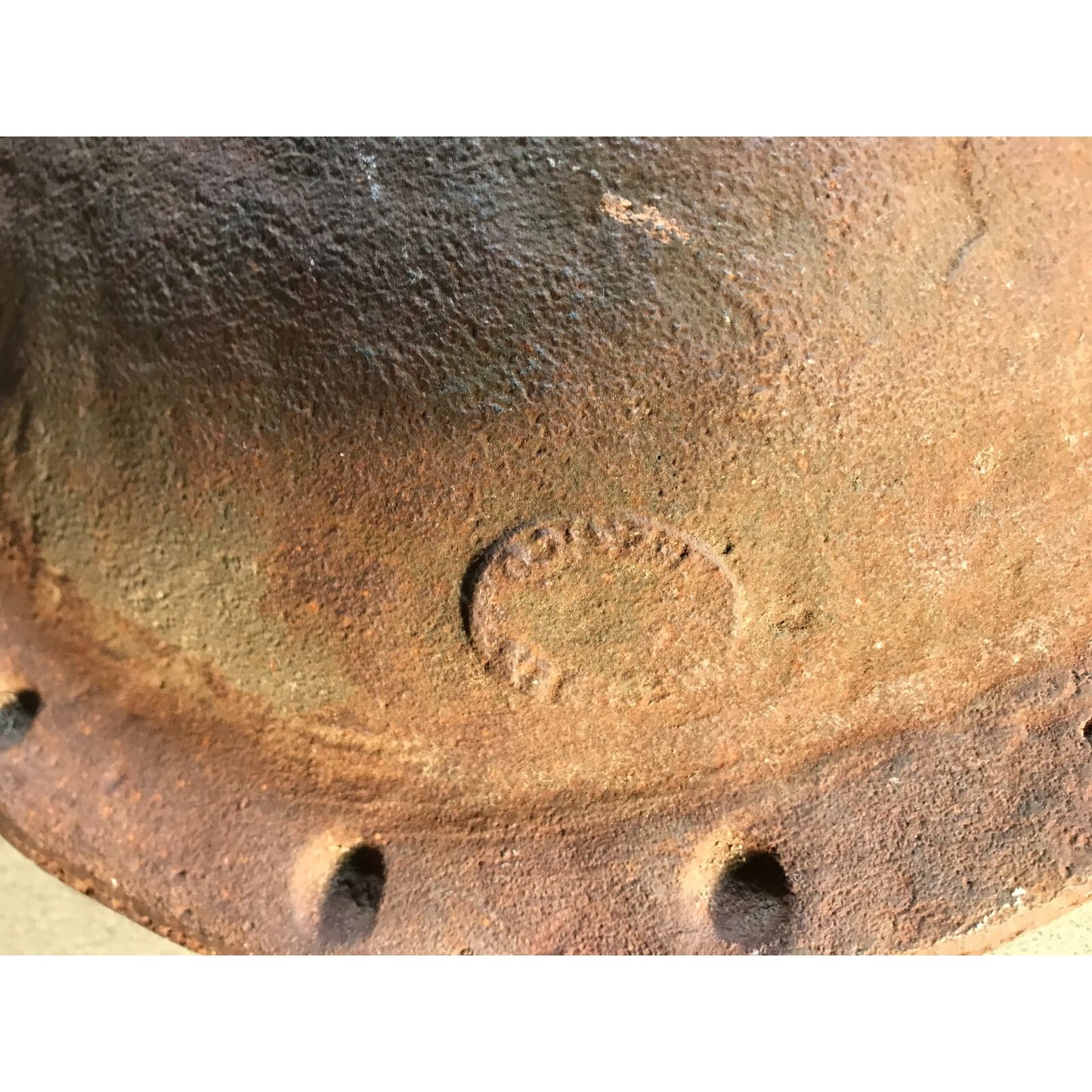 Antique Solid Iron Fire Cooking Bowl closeup of makers mark