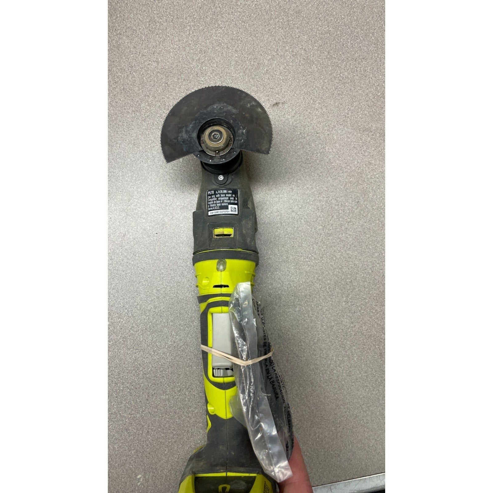 Ryobi P570 ONE+ 18V Oscillating Multi Tool underside view with blade, controls and product label visible
