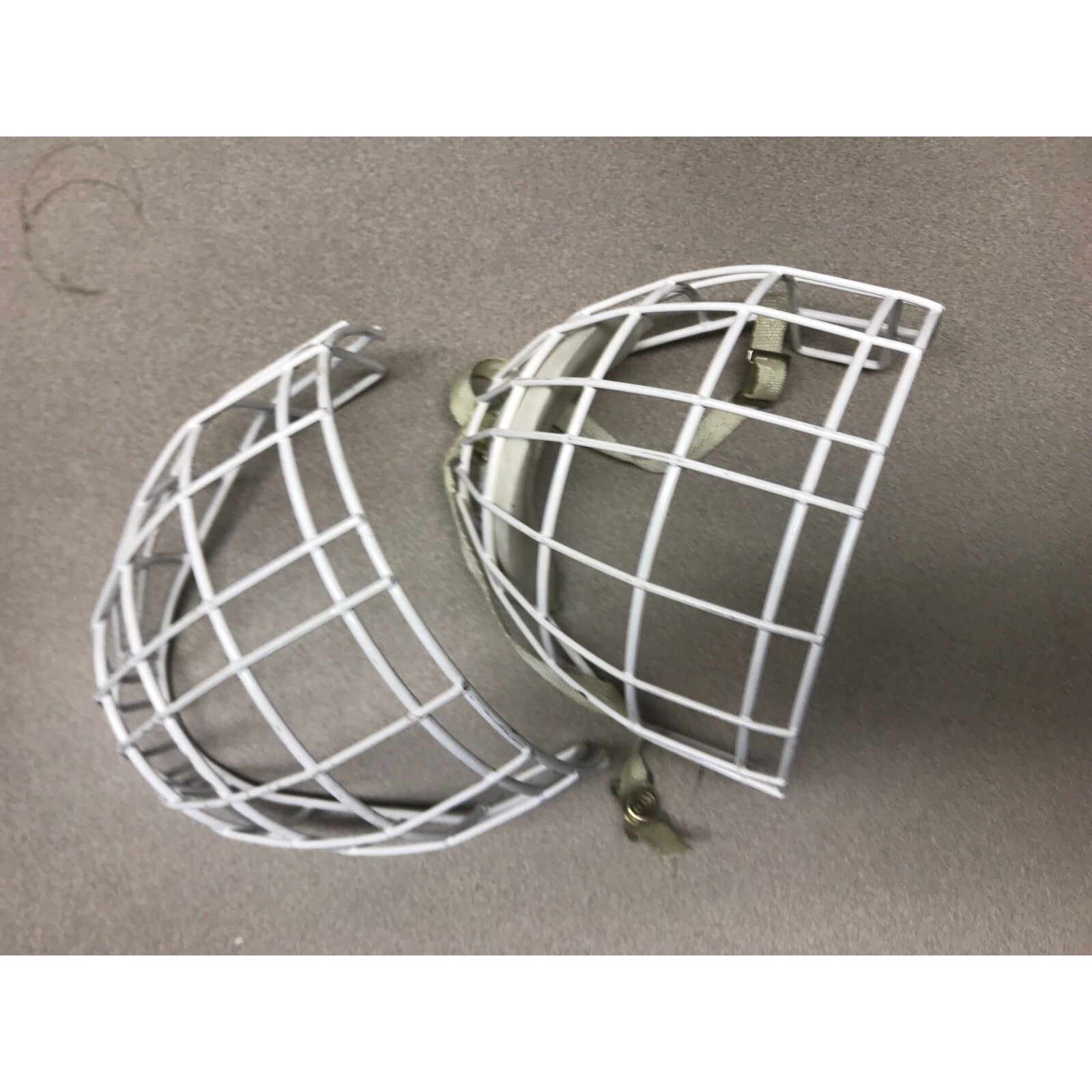 Two Hockey Cage Masks White Metal 7.5 inch (one with chin pad) front view